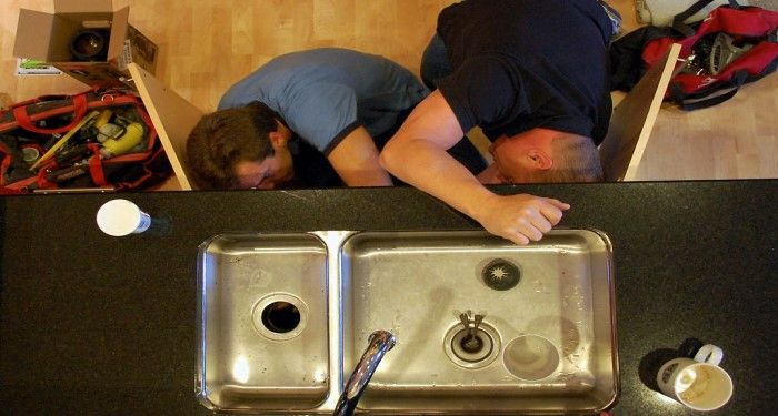 men replacing a sink