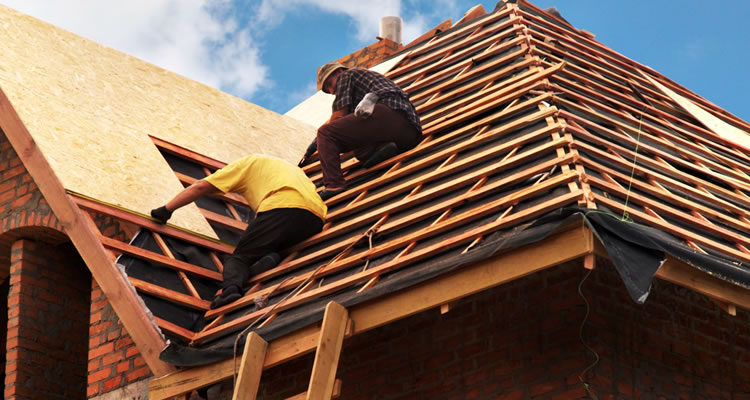 two roofers on a roof