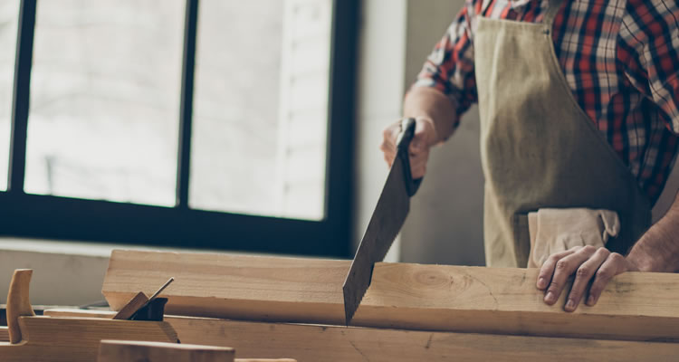 person sawing wood