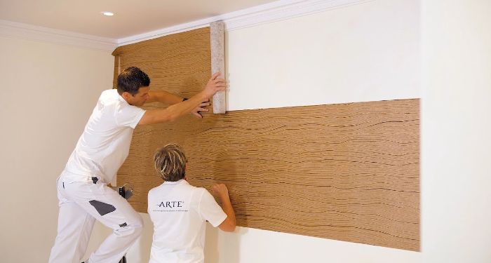 two men wallpapering