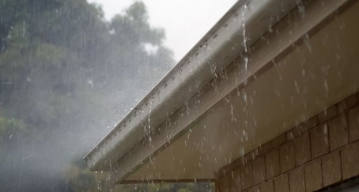 overflowing gutter due to rain